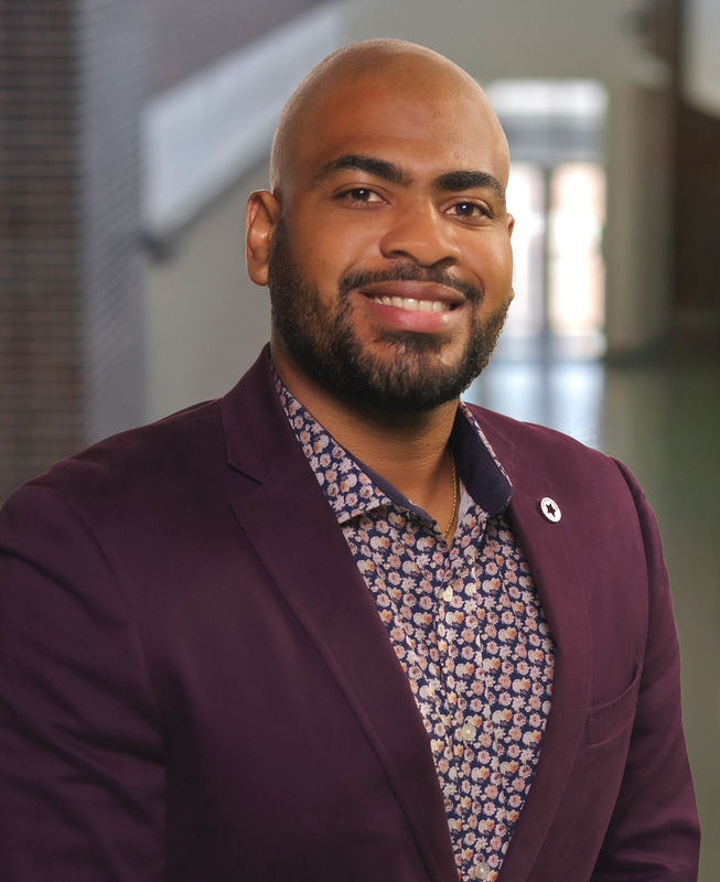 African American man wearing purple printed shirt and suit jacket