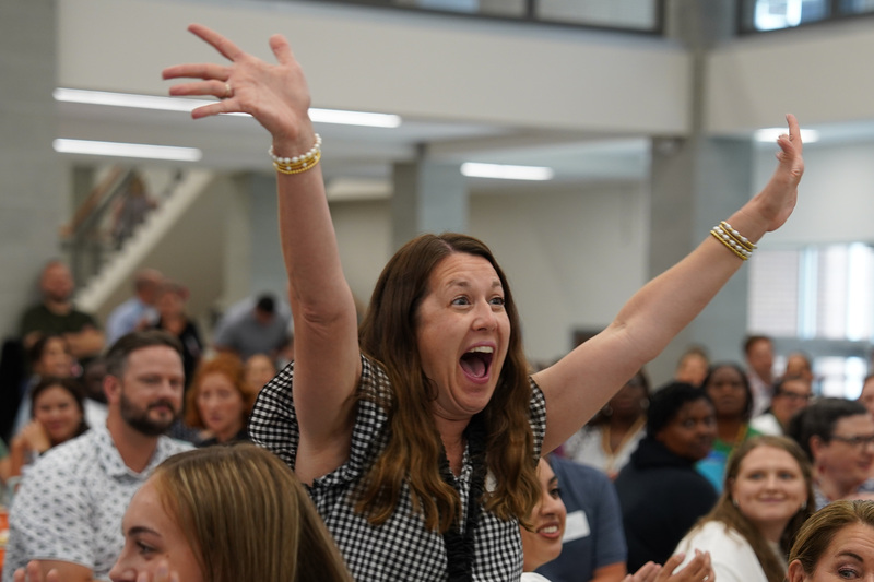woman with arms in air and excited expression on her face