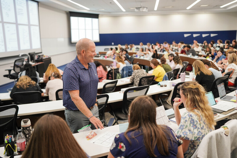Presenter works with educators at math symposium