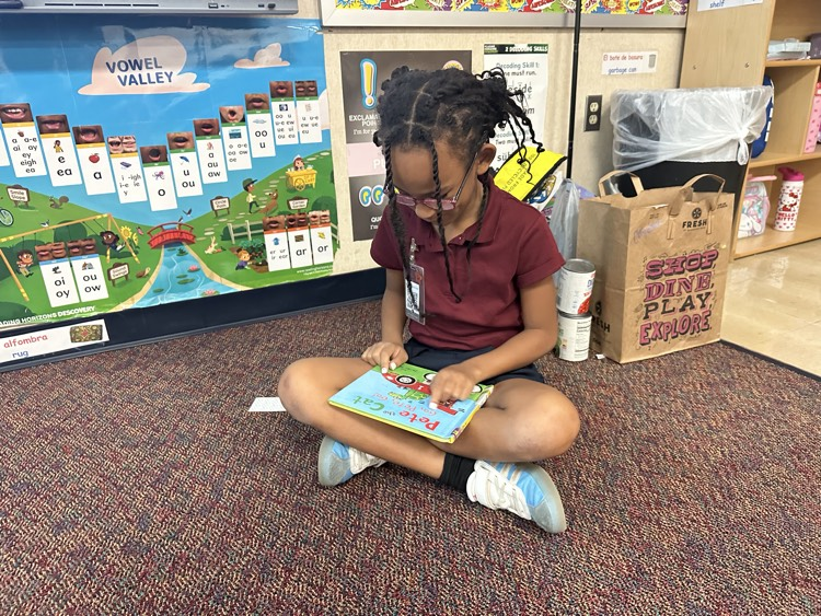 reading a Clifford book in the floor