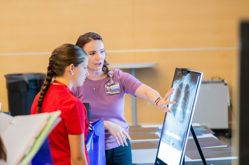 woman explaining xray to a teen girl