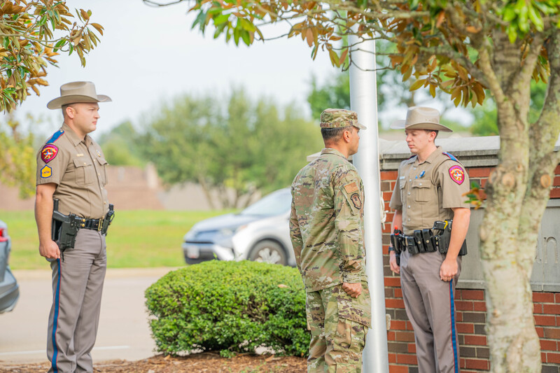 Sherriff officers and Army member standing together