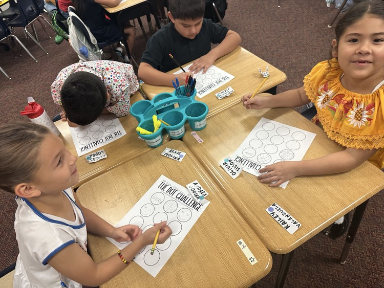 students sitting at desk making dots on Dot Day