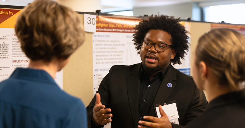 African American man talking to two Caucasian women