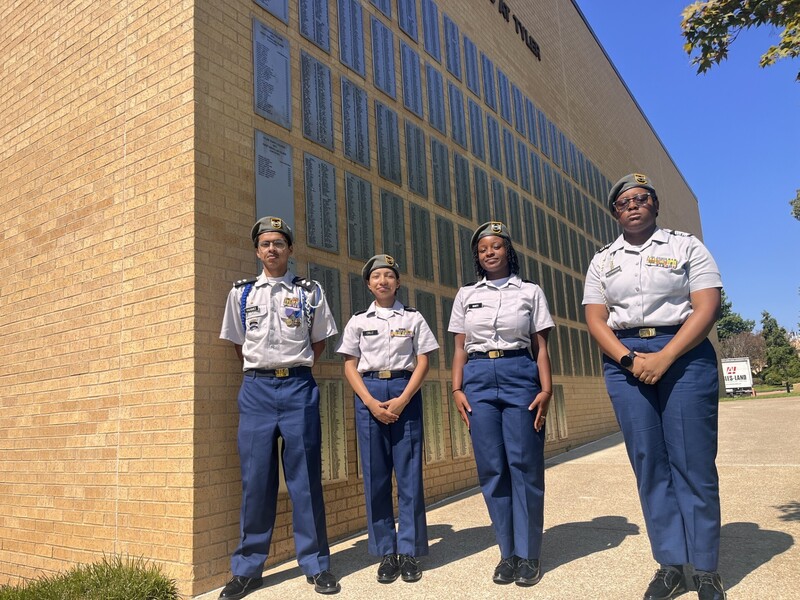 teens in their ROTC uniforms outside a school