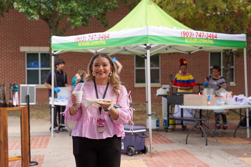 woman carrying plate of food outside