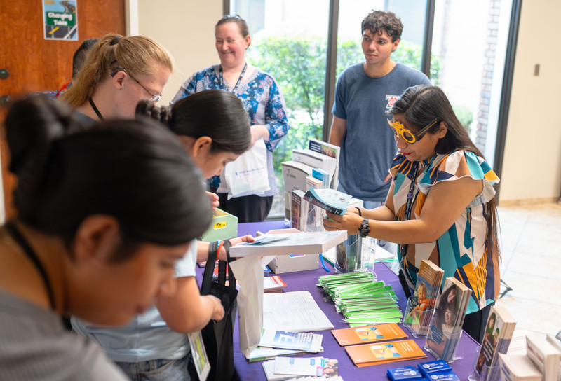 teens visiting vendor booths to get learning materials