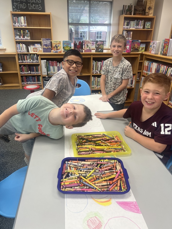 Students designing their dots on Dot Day in the library.