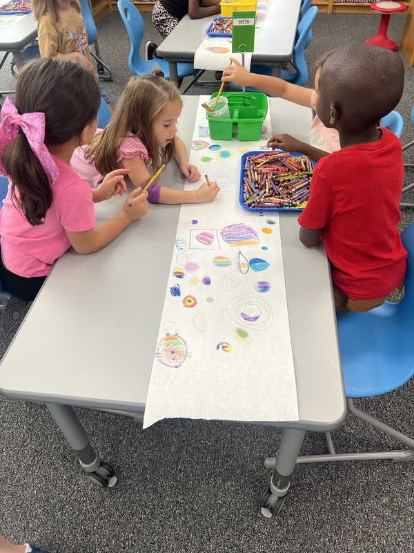 Students designing their dots on Dot Day in the library.