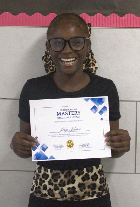 student holding a certificate