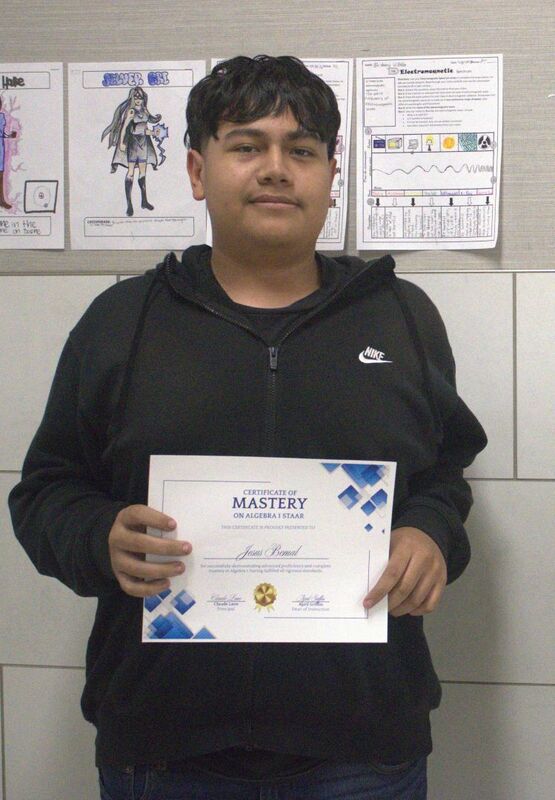 student holding a certificate