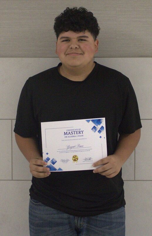 student holding a certificate