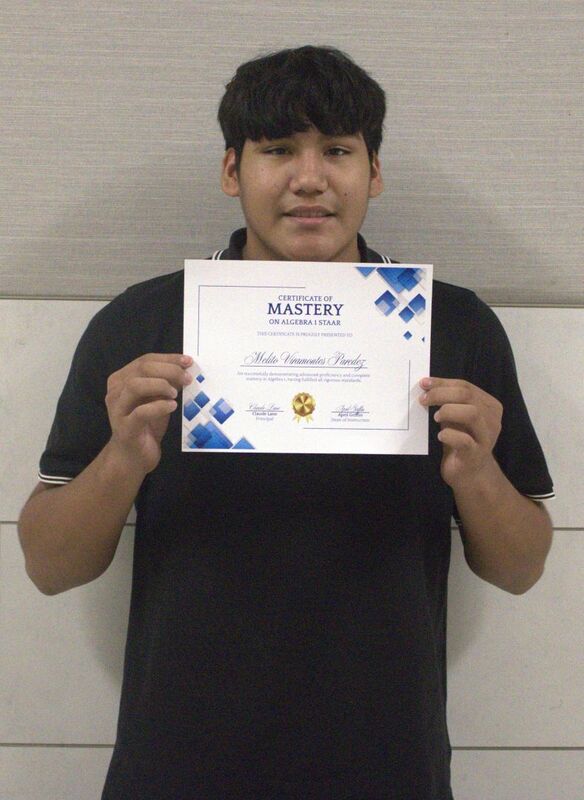 student holding a certificate