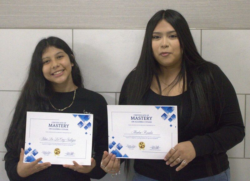 2 students holding a certificate