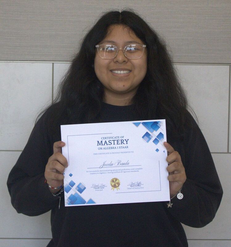 student holding a certificate