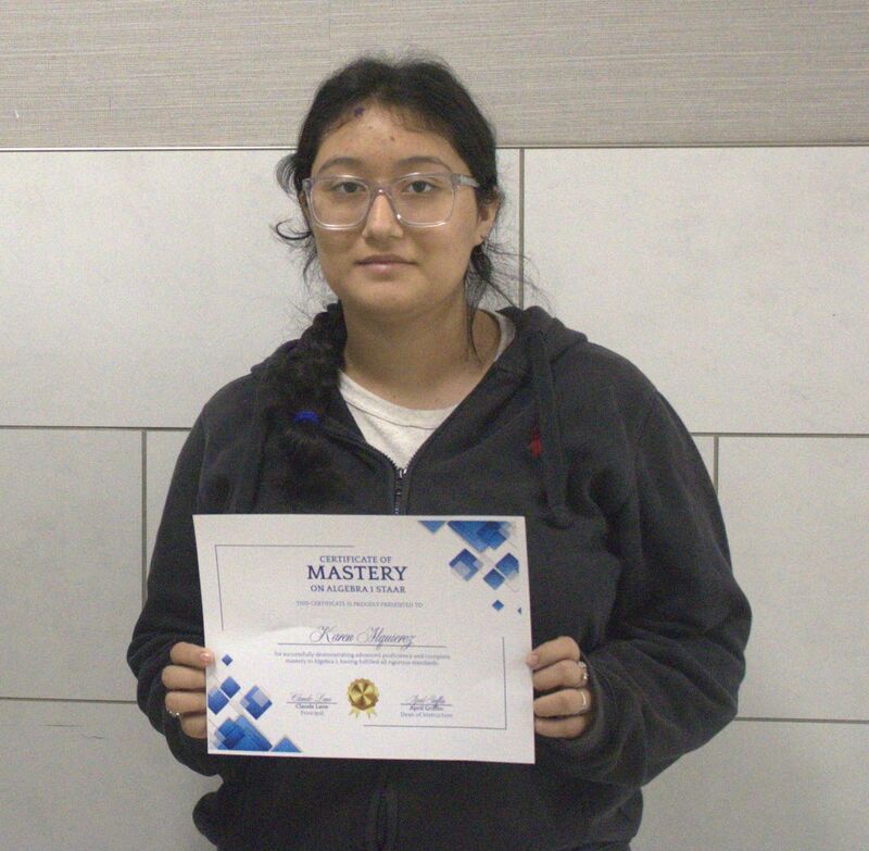 student holding a certificate