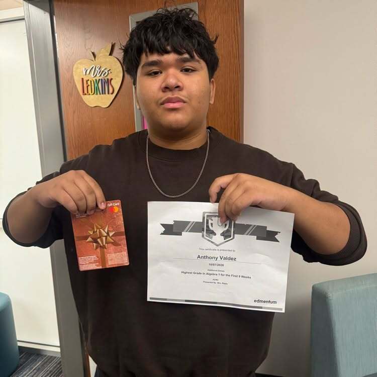 student holding a certificate