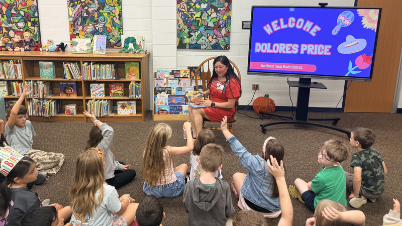 Dolores Price reading to students at Owens Elementary for Hispanic Heritage Month