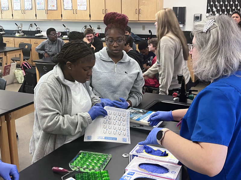 teen girls working with lab samples in classroom