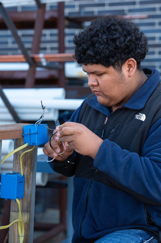 teen boy working on electrical wiring