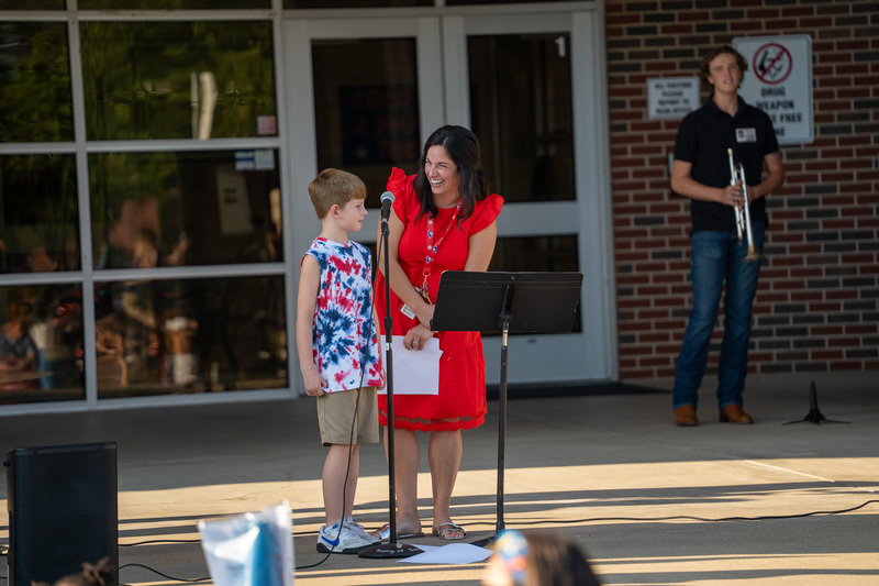 woman and child talking in front of school
