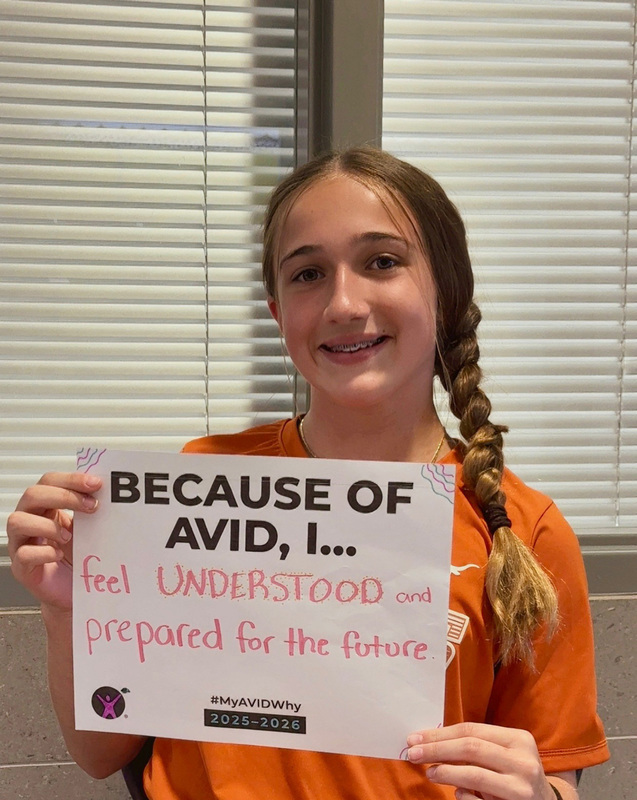 teen girl holding a sign
