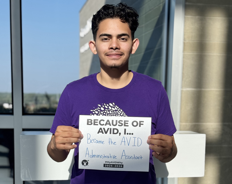 young man holding a sign