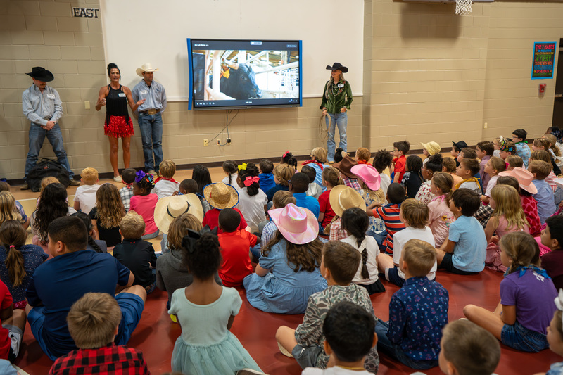 cowboys talking to elementary kids