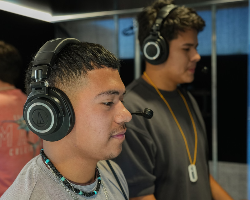 two teen boys with headsets on