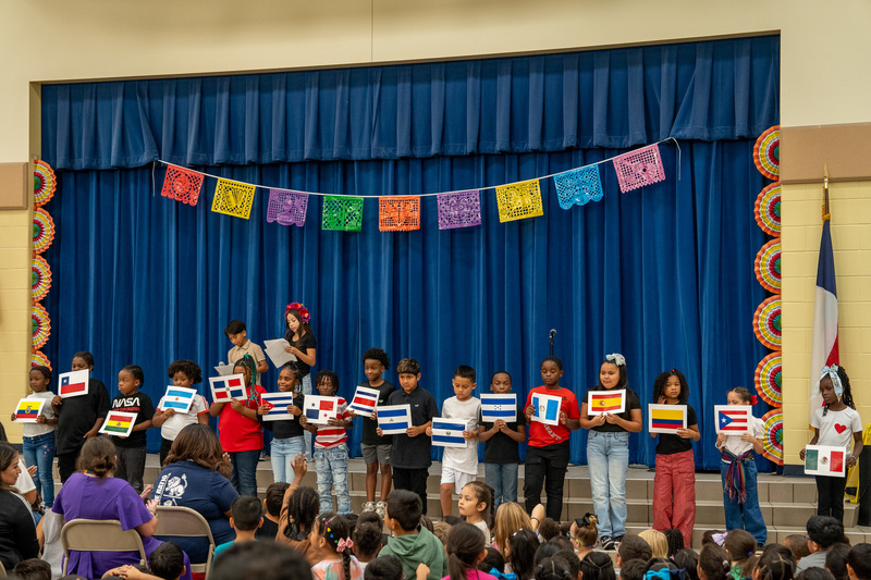 elementary age students on stage singing