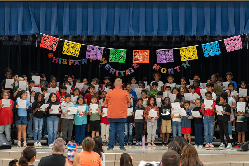elementary age students on stage singing