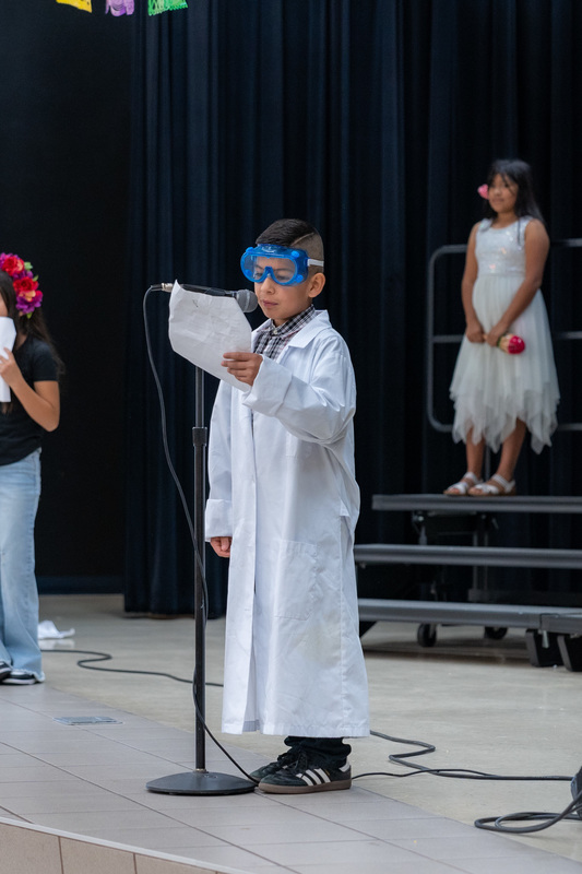 elementary boy on stage talking