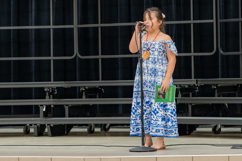 elementary girl on stage singing