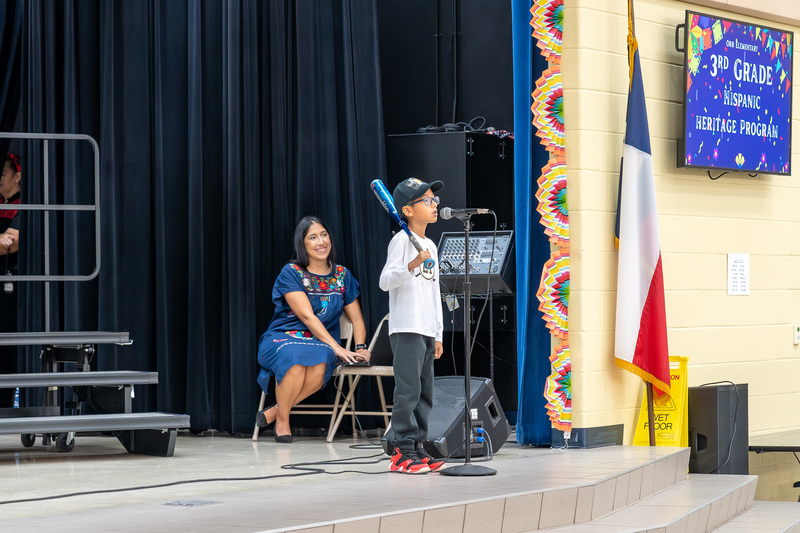 elementary boy on stage talking