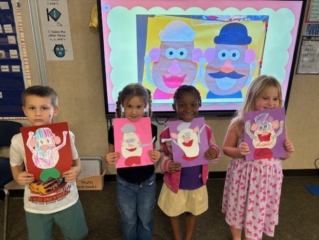 students showing their mr. and mrs. potato head art