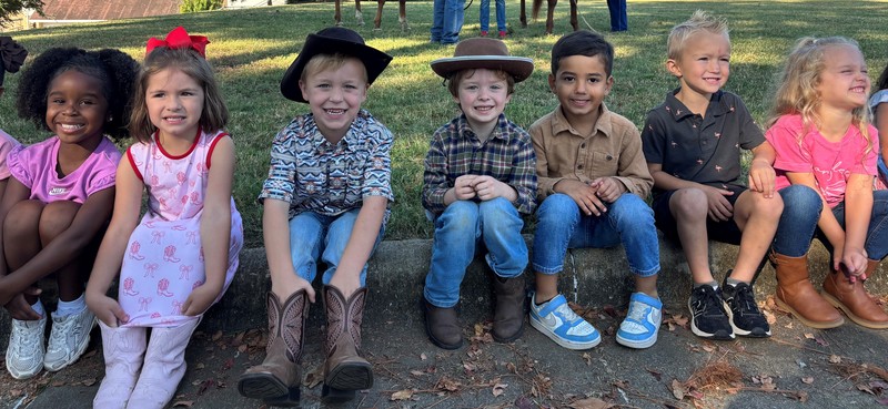 young kids sitting on curb