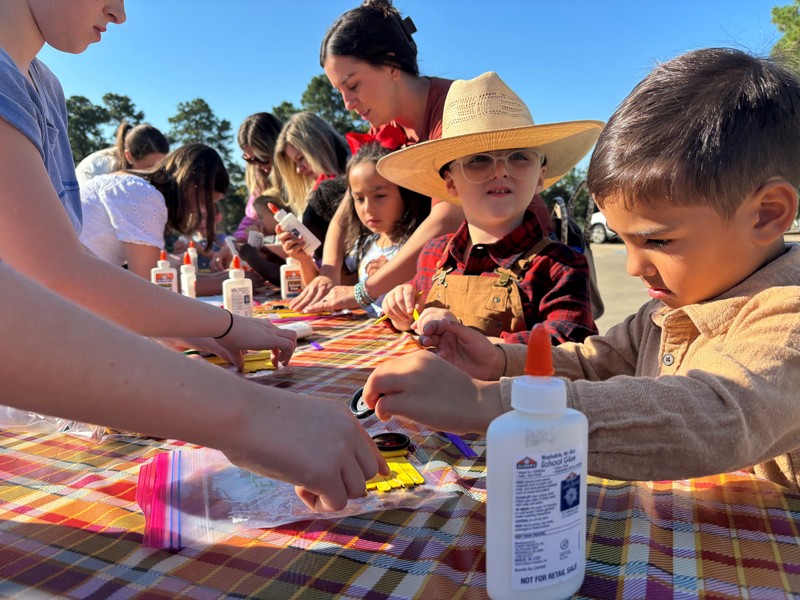 young kids doing crafts at a table