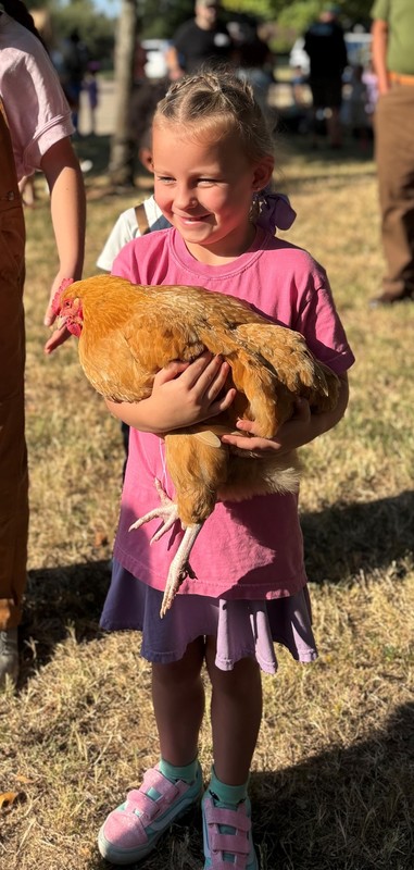 young girl holding a chicken