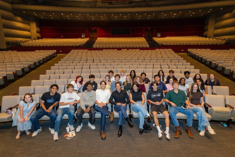 high school students in auditorium seating with Rob Lowe in middle of them