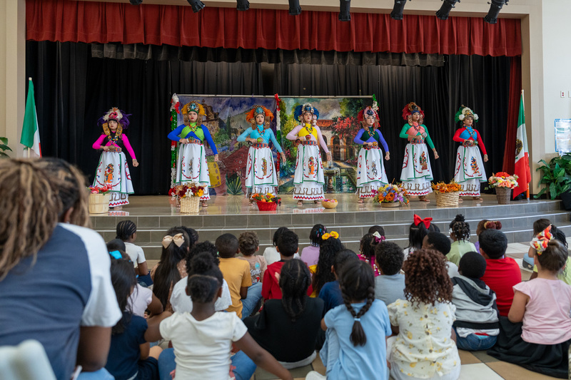 women in traditional Hispanic attire on stage