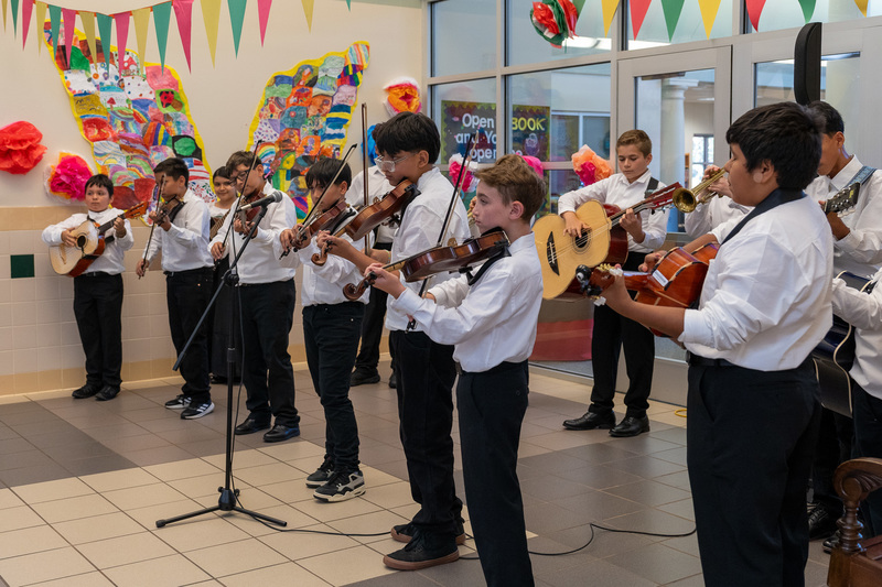 elementary kids playing mariachi instruments