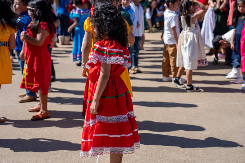 girl in red dress standing in crowd