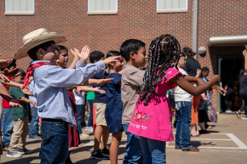 elementary kids dancing in line outside school