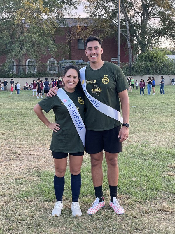 man and woman next to each other on soccer field