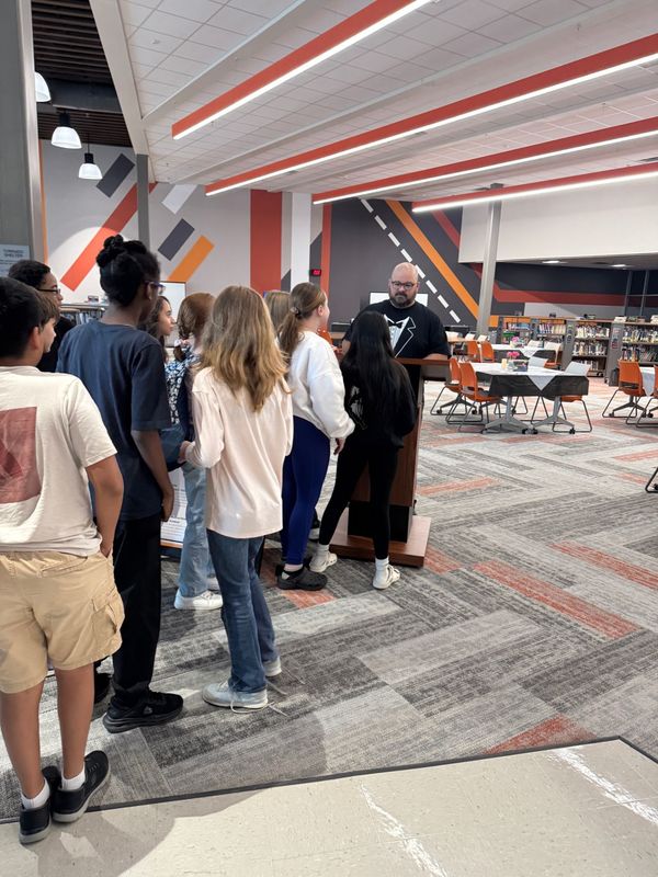 students lined up at maitre d station waiting to be seated.