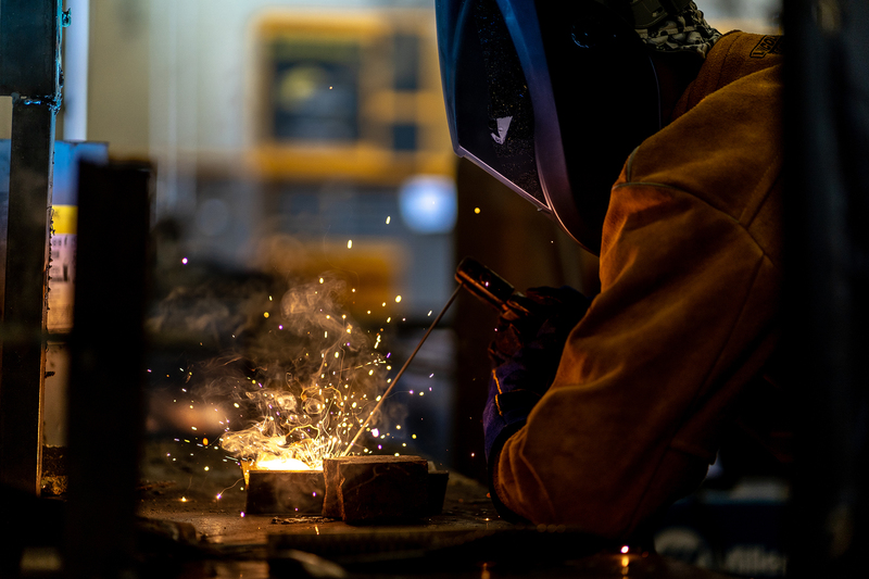 sparks flying from torch where welder is working