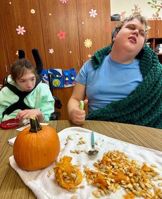 students exploring a pumpkin