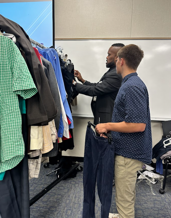 man and teen boy looking at clothes