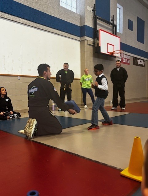 students learning martials arts in PE class