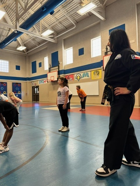 students learning martials arts in PE class